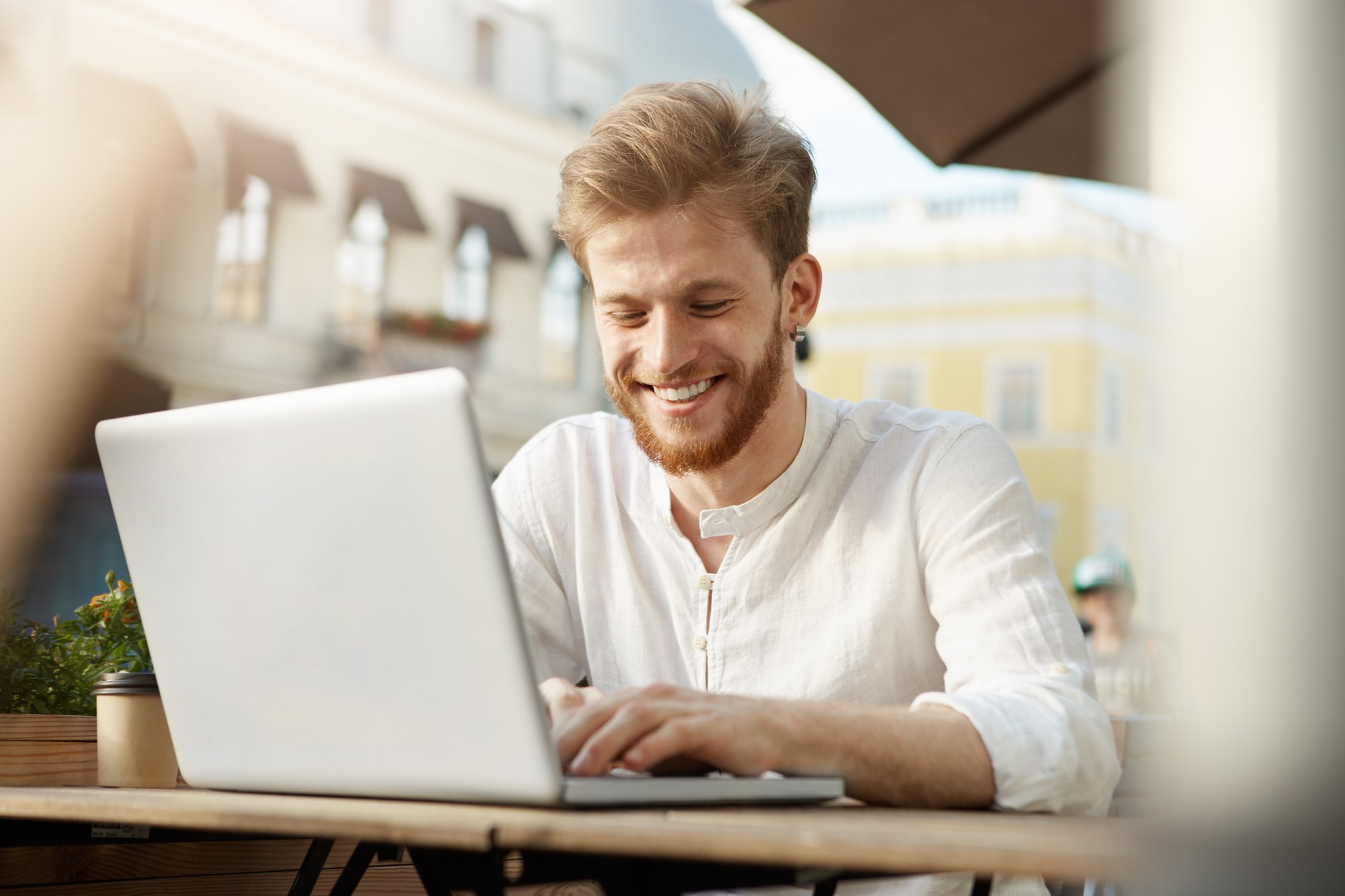 adult-ginger-handsome-man-with-laptop-computer-sitting-terrace-restaurant-cafe